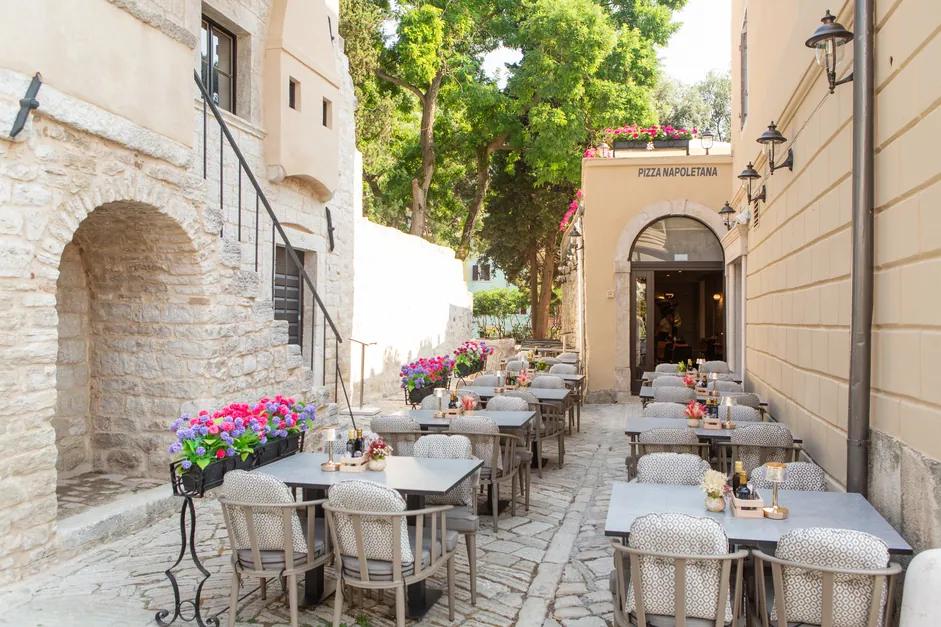 The lane of tables under the old town wall