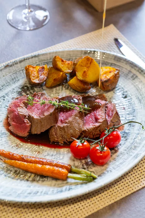 Green peppercorn sauce poured over the beef fillet
